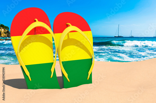 Flip flops with Bolivian flag on the beach. Bolivia resorts, vacation, tours, travel packages concept. 3D rendering
