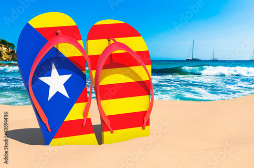 Flip flops with Catalan flag on the beach. Catalonia resorts, vacation, tours, travel packages concept. 3D rendering