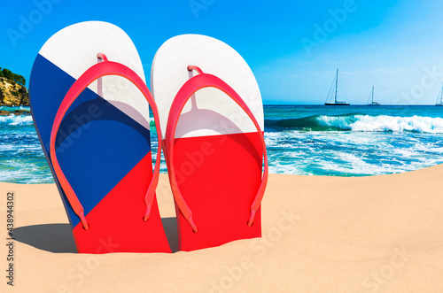 Flip flops with Czech flag on the beach. Czech Republic resorts, vacation, tours, travel packages concept. 3D rendering