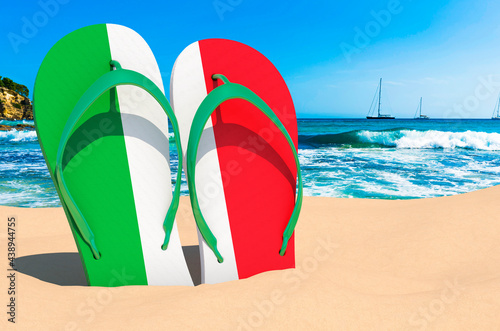 Flip flops with Italian flag on the beach. Italy resorts, vacation, tours, travel packages concept. 3D rendering