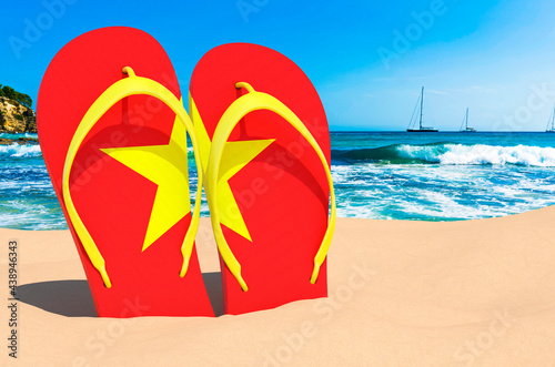 Flip flops with Vietnamese flag on the beach. Vietnam resorts, vacation, tours, travel packages concept. 3D rendering
