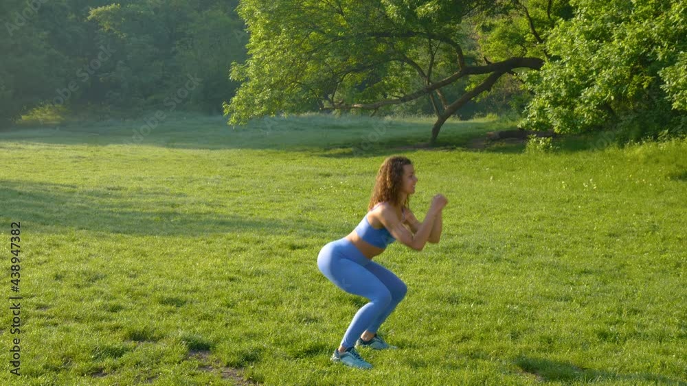 Young beautiful girl doing fitness workout on the grass in the park Young beautiful girl doing fitness workout on the grass in the park
