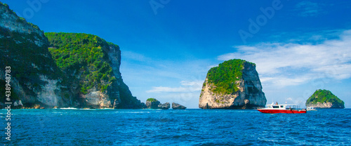 rocky islands in tropical sea, diving site manta point near nusa penida bali indonesia, panoramic shot