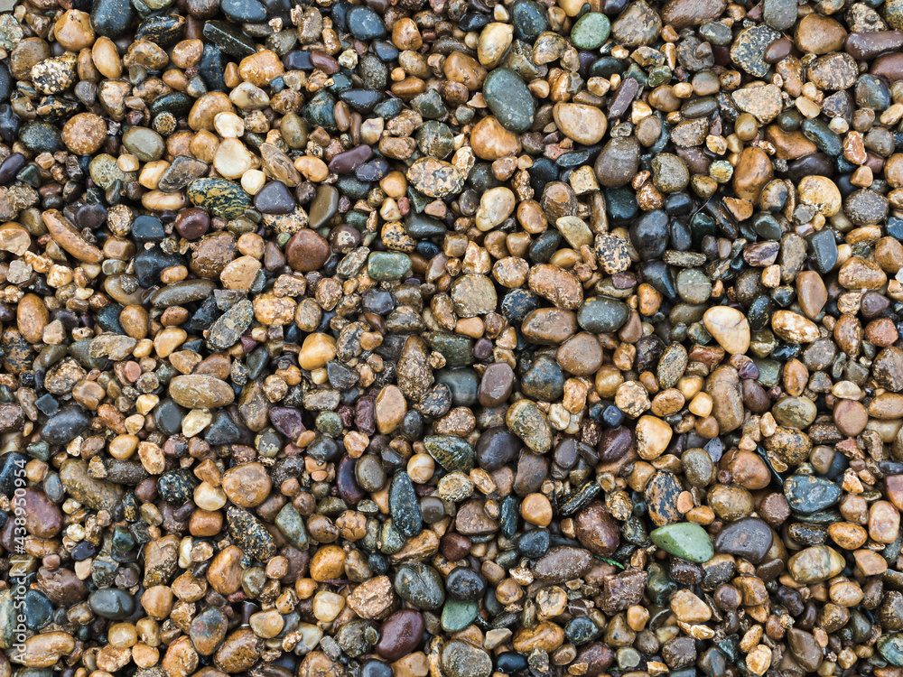 texture: many small stones of different colors close-up - decorative fence texture: many small stones of different colors close-up - decorative fence
