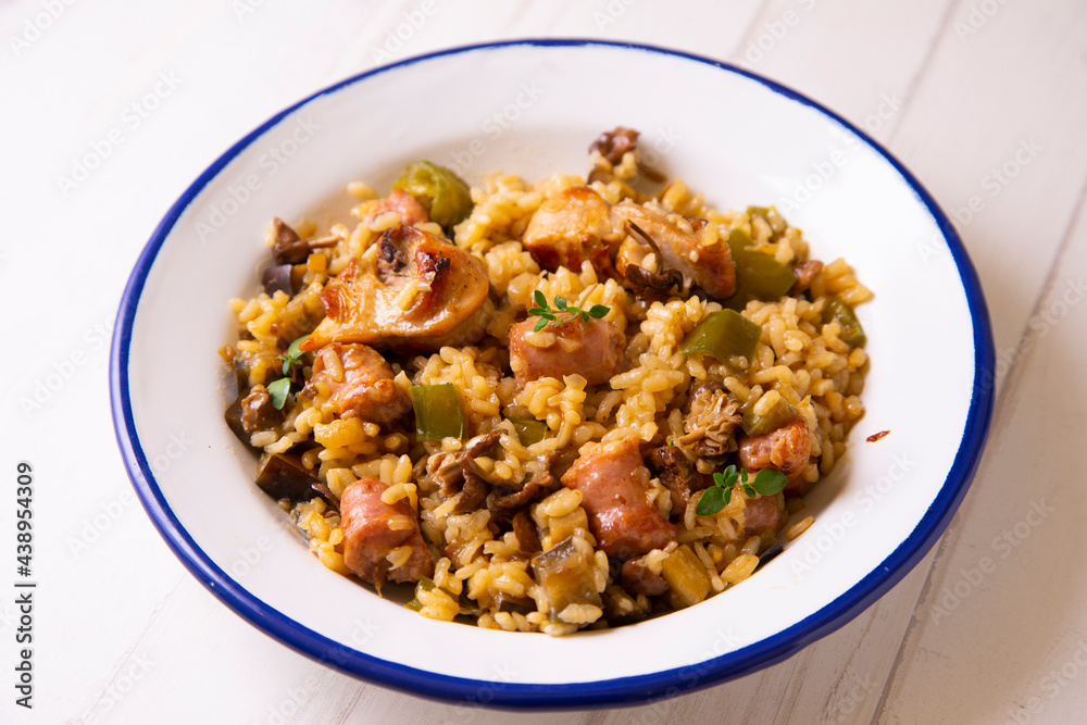 Spanish paella with rabbit, sausages, vegetables and artichokes. Traditional recipe from the Mediterranean area. Spanish paella with rabbit, sausages, vegetables and artichokes. Traditional recipe from the Mediterranean area.