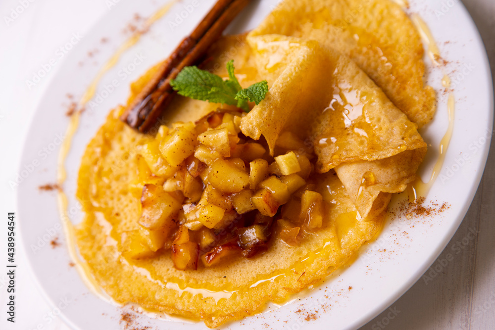 Mini crepes with apple compote and cinnamon. Traditional French recipe. Mini crepes with apple compote and cinnamon. Traditional French recipe.