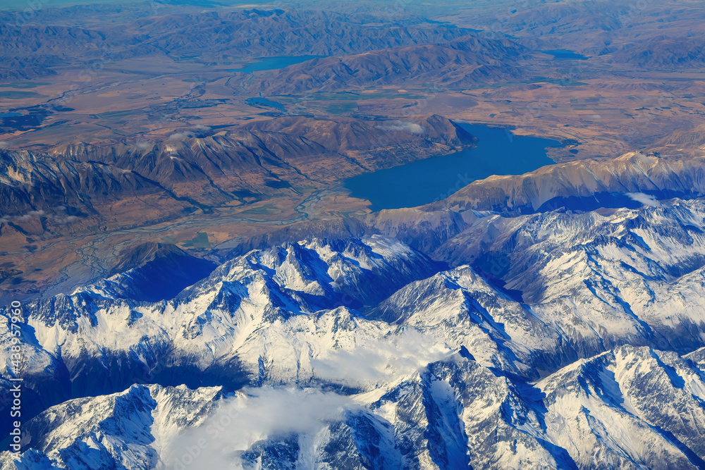 Naklejka premium Aerial view of the snowy mountains of the Southern Alps in the South Island of New Zealand. Behind them are Lake Ohau and the Hopkins River