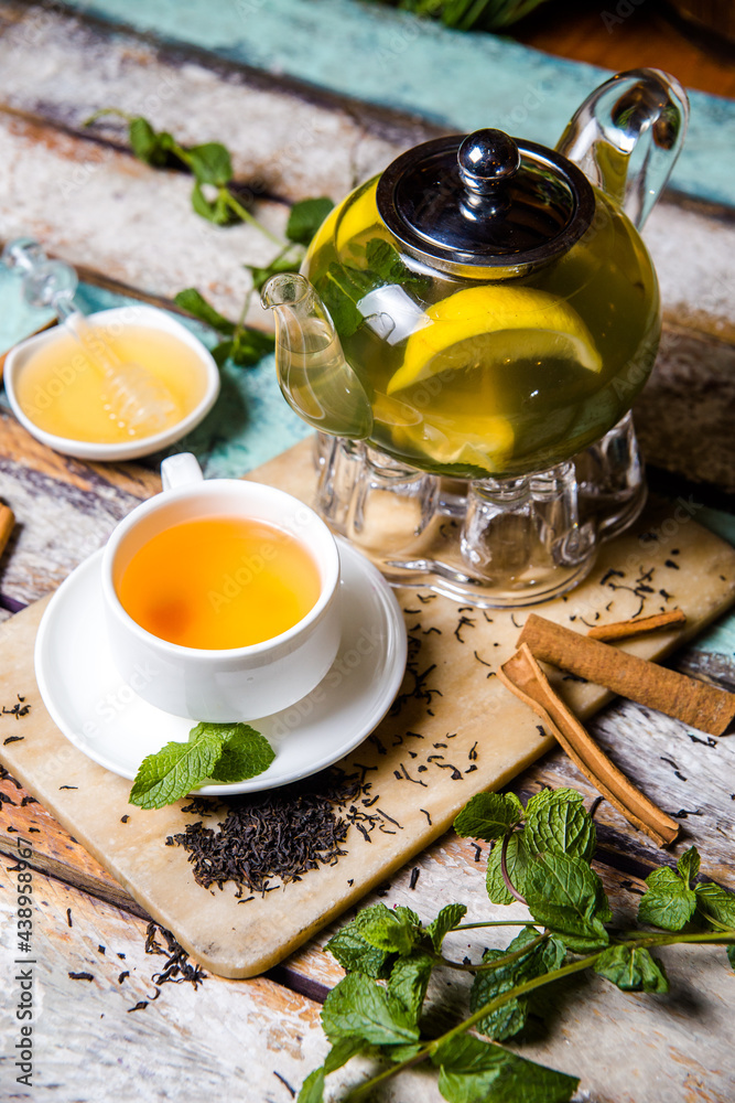 teapot green tea with lemon, mint and cinnamon food photo teapot green tea with lemon, mint and cinnamon food photo