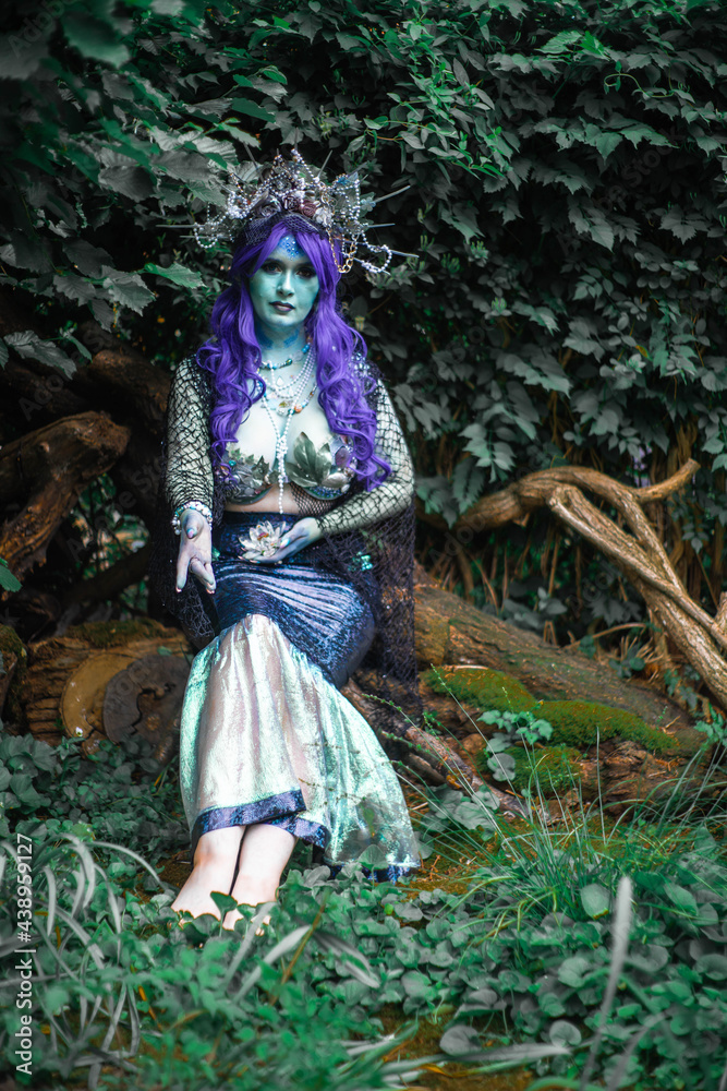 fabulous dark mermaid with blue skin in the forest close up fabulous dark mermaid with blue skin in the forest close up