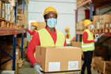 Black man in protective mask working in warehouse