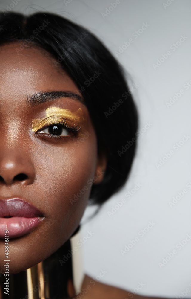 Cropped headshot of young black woman with natural skin, posing in the studio. Cropped headshot of young black woman with natural skin, posing in the studio.