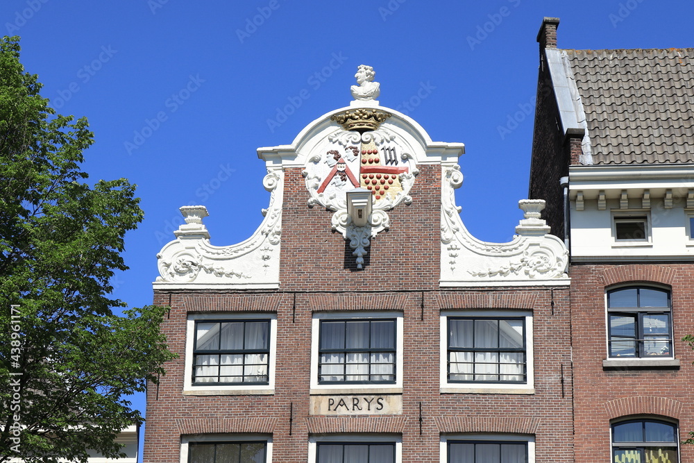 Amsterdam Historic Oudezijds Voorburgwal Canal House with Decorated Neck Gable, Gable Stone and Sculpture