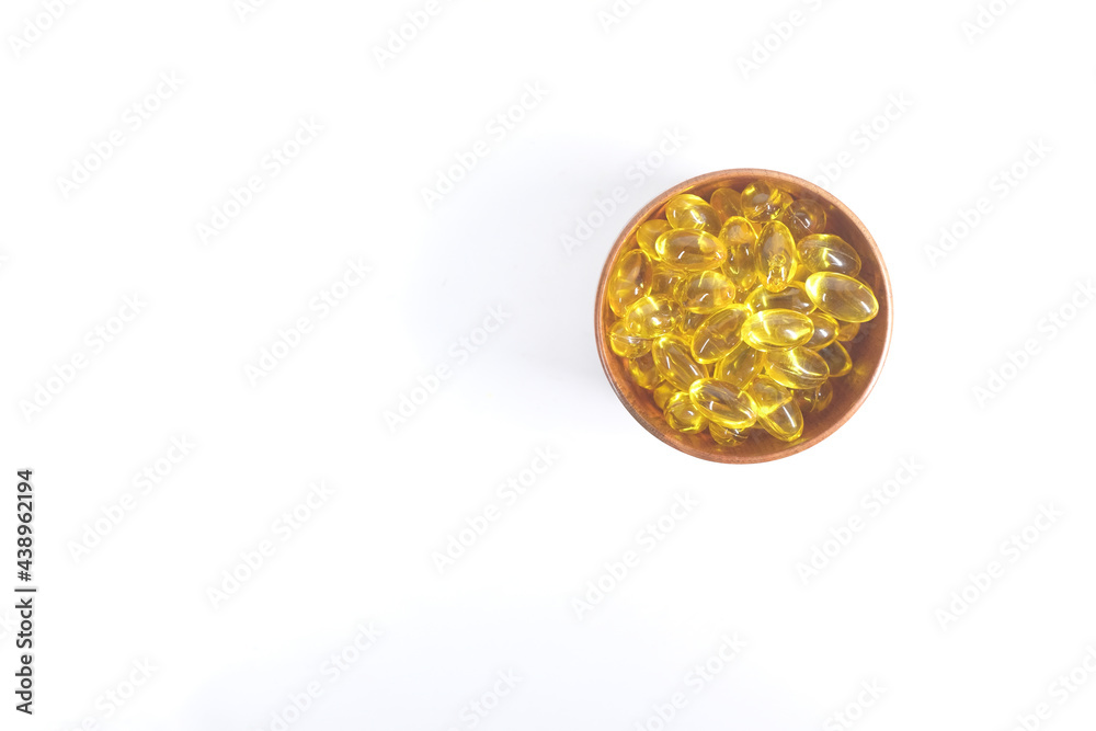 fish oil supplement in a bowl on white background 