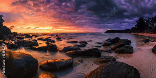 The evening sun hits the rock .Sunset on the beach © mon