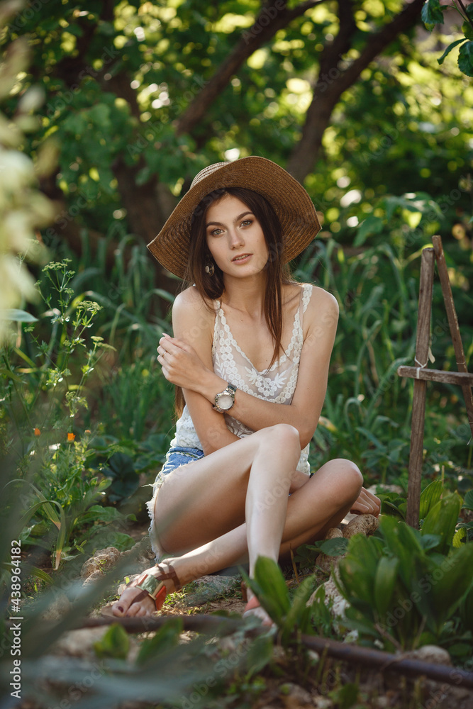 Beautiful young woman gardening outside in summer nature Beautiful young woman gardening outside in summer nature