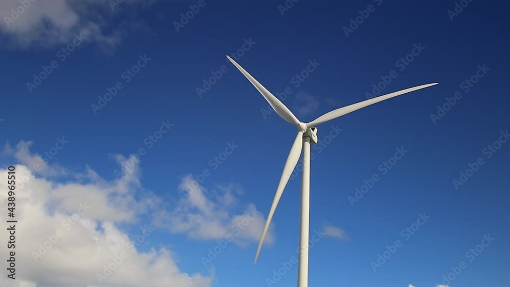 Single wind turbine with blue sky and clouds Single wind turbine with blue sky and clouds