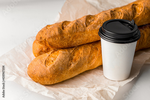 Fresh baked french baguettes with a cup of coffee photo