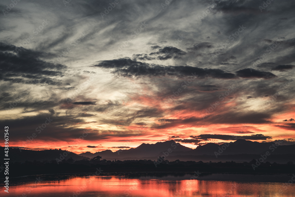 Sunset over the mountains and lake Sunset over the mountains and lake