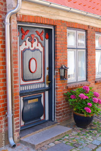 Beautiful decorated entrance with ornamental wooden door (Jutland, Denmark)