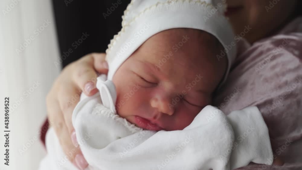 Newborn sleeps on hands of parent. discharge from hospital