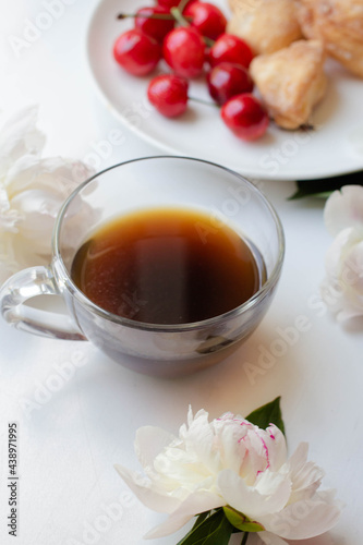 coffee, homemade cookies and cherry with peony flowers