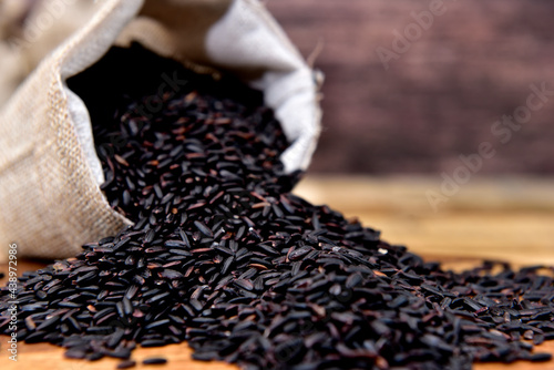 Organic black rice in a rustic sack
