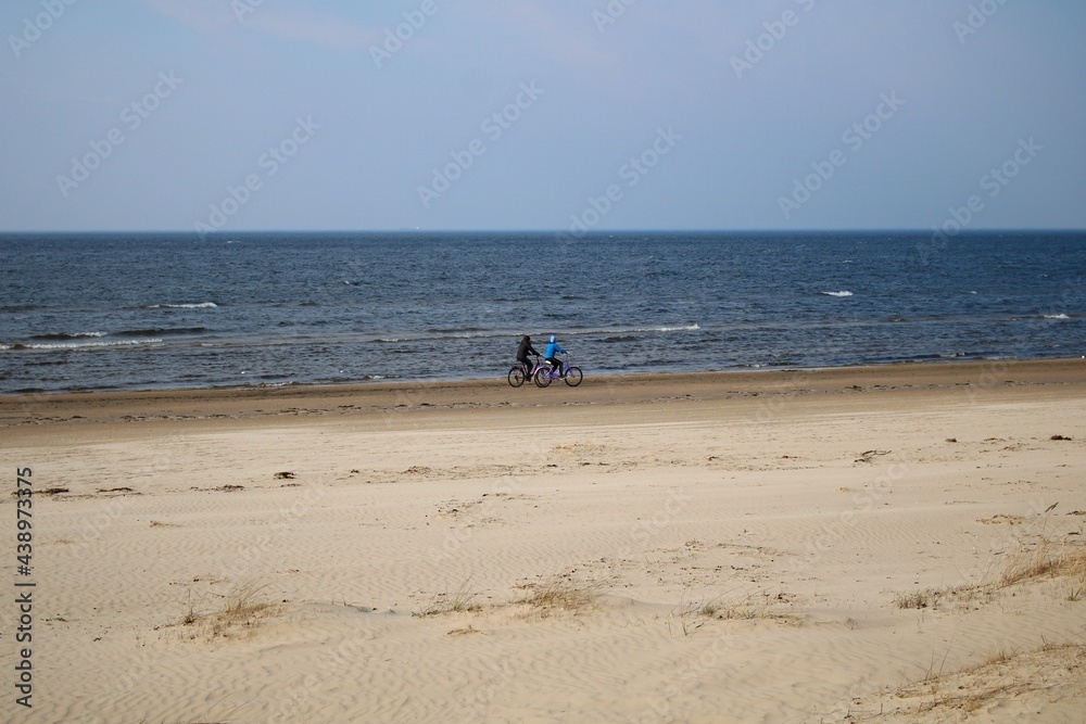 Bike ride along the sandy shore of the cold gulf of Riga on April 7, 2020