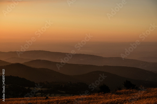 Sunset in front of the silhouette of the mountains and the wheat fields of North Lebanon
