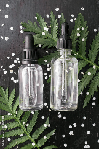 Cosmetic bottle containers with green herbal leaves, Blank label for branding mock-up, Natural beauty