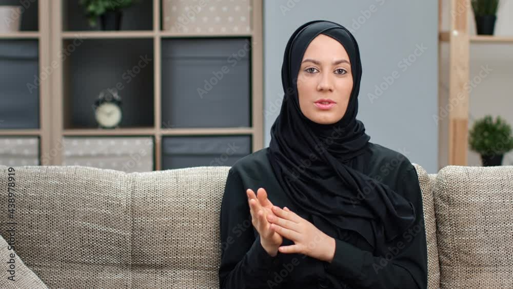 Portrait of smiling ethnic Muslim female blogger talking recording video call online broadcasting Portrait of smiling ethnic Muslim female blogger talking recording video call online broadcasting