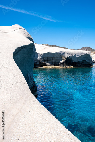 Fototapeta Naklejka Na Ścianę i Meble -  Sarakiniko beach at Milos island, Cyclades Greece. White rock formations, cliffs and caves over blue sea