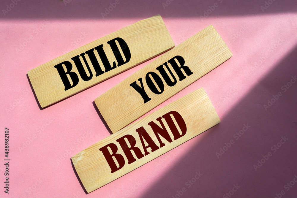 Phrase BUILD YOUR BRAND written on wooden blocks. With vintage styled background. Branding rebranding marketing concept. Phrase BUILD YOUR BRAND written on wooden blocks. With vintage styled background. Branding rebranding marketing concept.