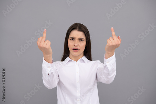 annoyed woman show middle finger. expressing disrespect. bad girl. rude aggressive hands gesturing. photo