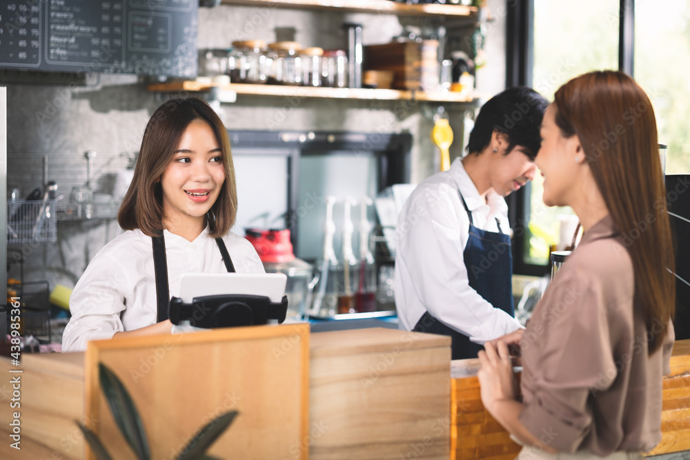 A customer orders a hot latte to the barista. Asian Staff coffee shop cafe making hot coffee and serve to customer. Small business sme concept.