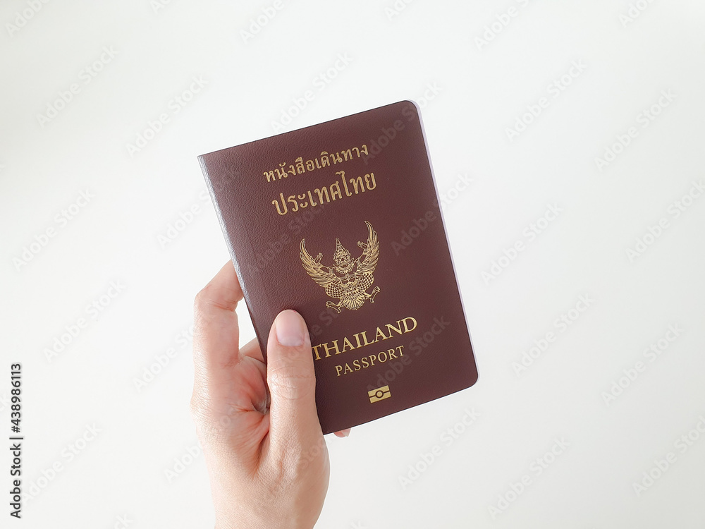 Image of persons hand holding passport on white background. Image of persons hand holding passport on white background.