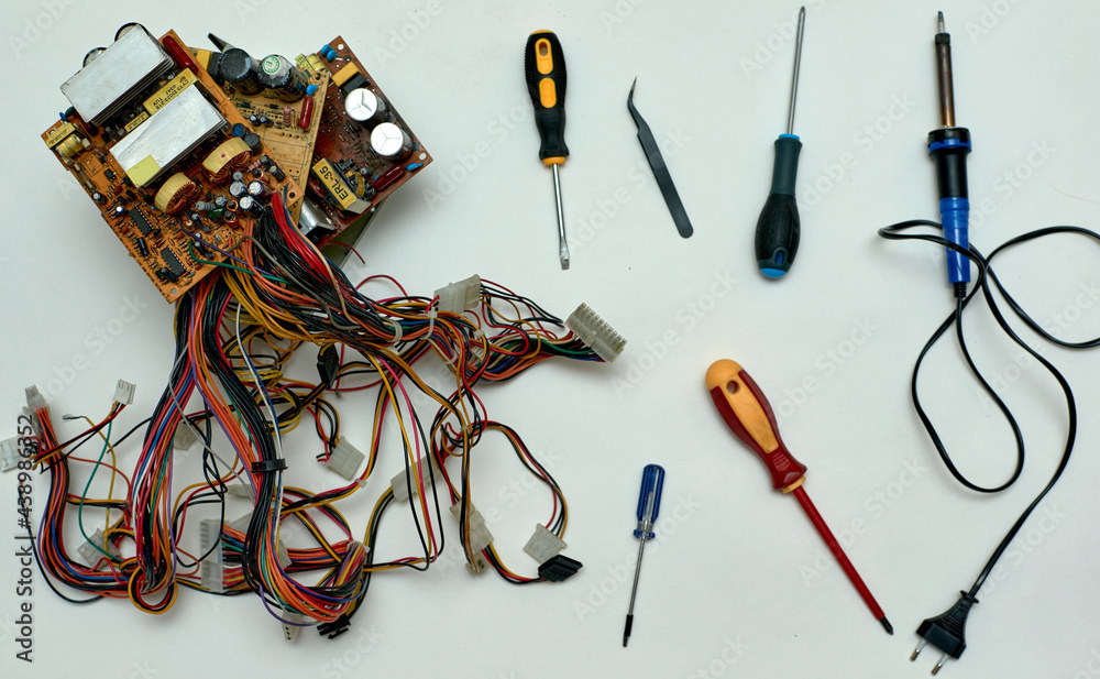 Disassembled power supply of a stationary personal computer on an isolated background. Repair of computer equipment.