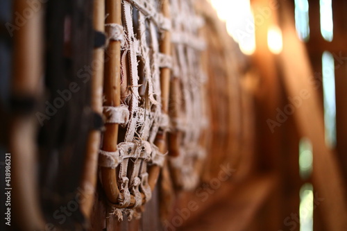Row of traditional snow shoes hanging on a wall in an old barn