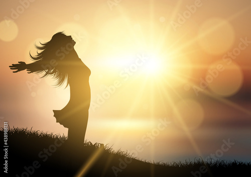 Happy female against a sunset landscape