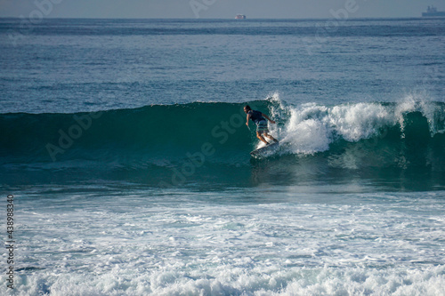 Surfer on perfect blue aquamarine wave, empty line up, perfect for surfing, clean water, Indian Ocean close to Mirissa