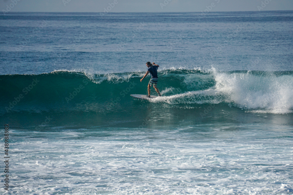 Surfer on perfect blue aquamarine wave, empty line up, perfect for surfing, clean water, Indian Ocean close to Mirissa Surfer on perfect blue aquamarine wave, empty line up, perfect for surfing, clean water, Indian Ocean close to Mirissa