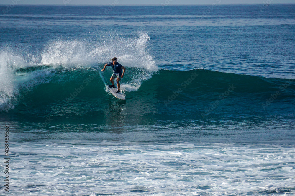 Surfer on perfect blue aquamarine wave, empty line up, perfect for surfing, clean water, Indian Ocean close to Mirissa Surfer on perfect blue aquamarine wave, empty line up, perfect for surfing, clean water, Indian Ocean close to Mirissa