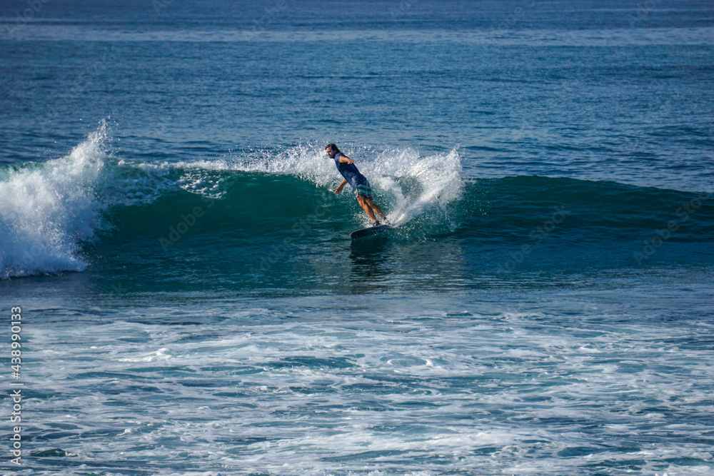 Surfer on perfect blue aquamarine wave, empty line up, perfect for surfing, clean water, Indian Ocean close to Mirissa