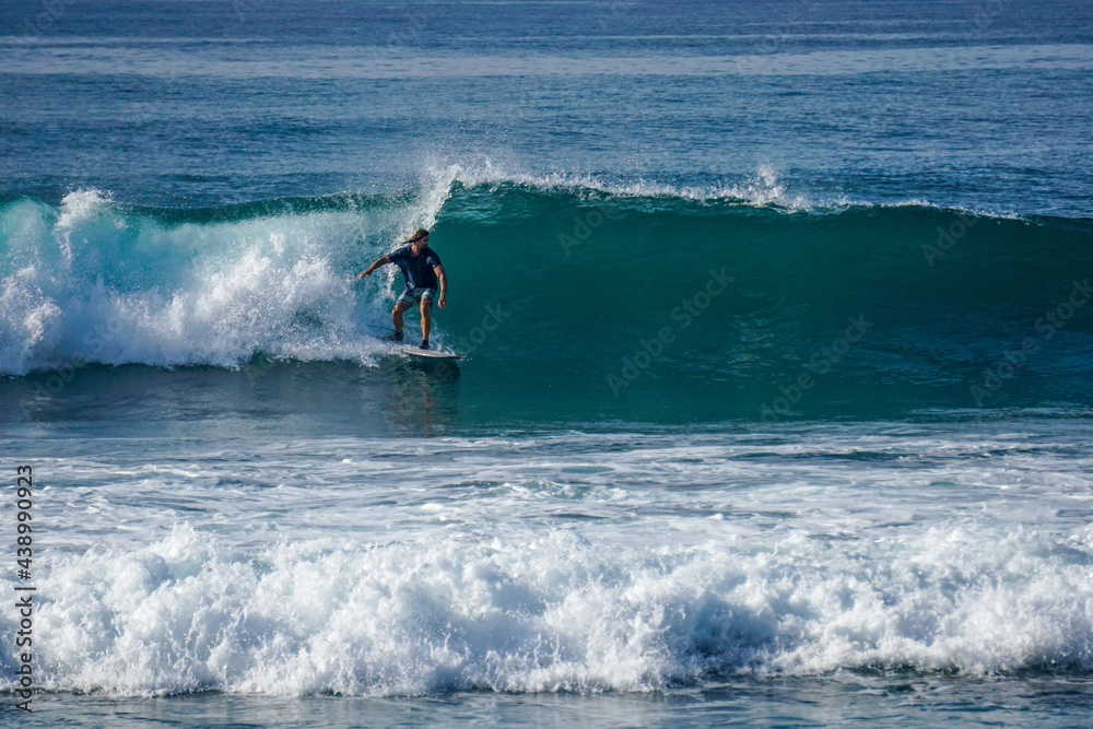 Surfer on perfect blue aquamarine wave, empty line up, perfect for surfing, clean water, Indian Ocean close to Mirissa Surfer on perfect blue aquamarine wave, empty line up, perfect for surfing, clean water, Indian Ocean close to Mirissa