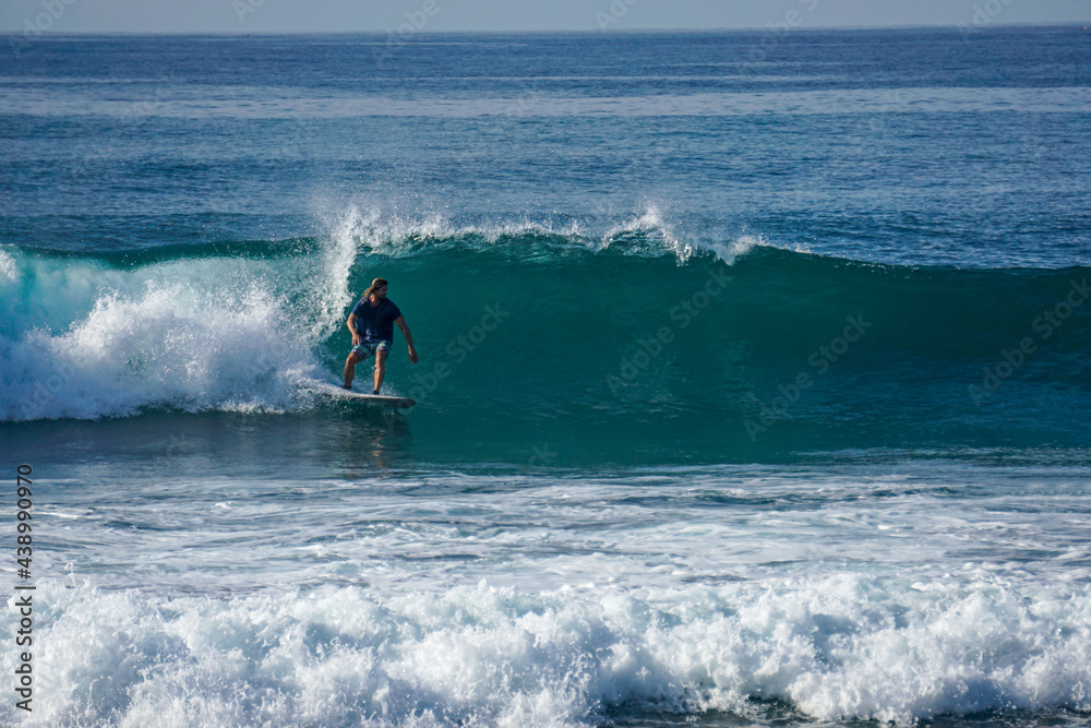 Surfer on perfect blue aquamarine wave, empty line up, perfect for surfing, clean water, Indian Ocean close to Mirissa Surfer on perfect blue aquamarine wave, empty line up, perfect for surfing, clean water, Indian Ocean close to Mirissa