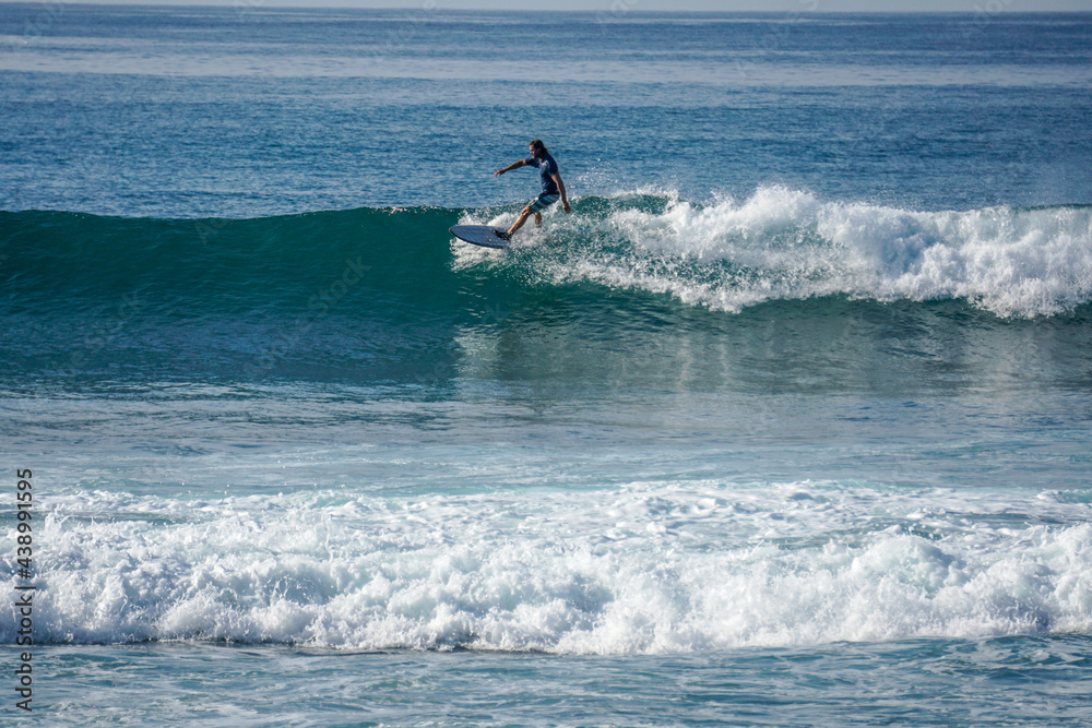 Surfer on perfect blue aquamarine wave, empty line up, perfect for surfing, clean water, Indian Ocean close to Mirissa Surfer on perfect blue aquamarine wave, empty line up, perfect for surfing, clean water, Indian Ocean close to Mirissa