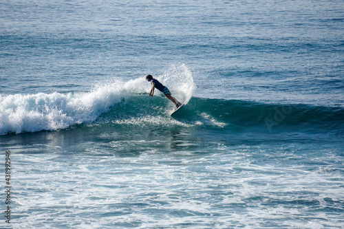 Surfer on perfect blue aquamarine wave, empty line up, perfect for surfing, clean water, Indian Ocean close to Mirissa