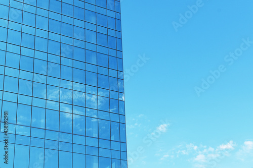 Glass building reflects the sky 