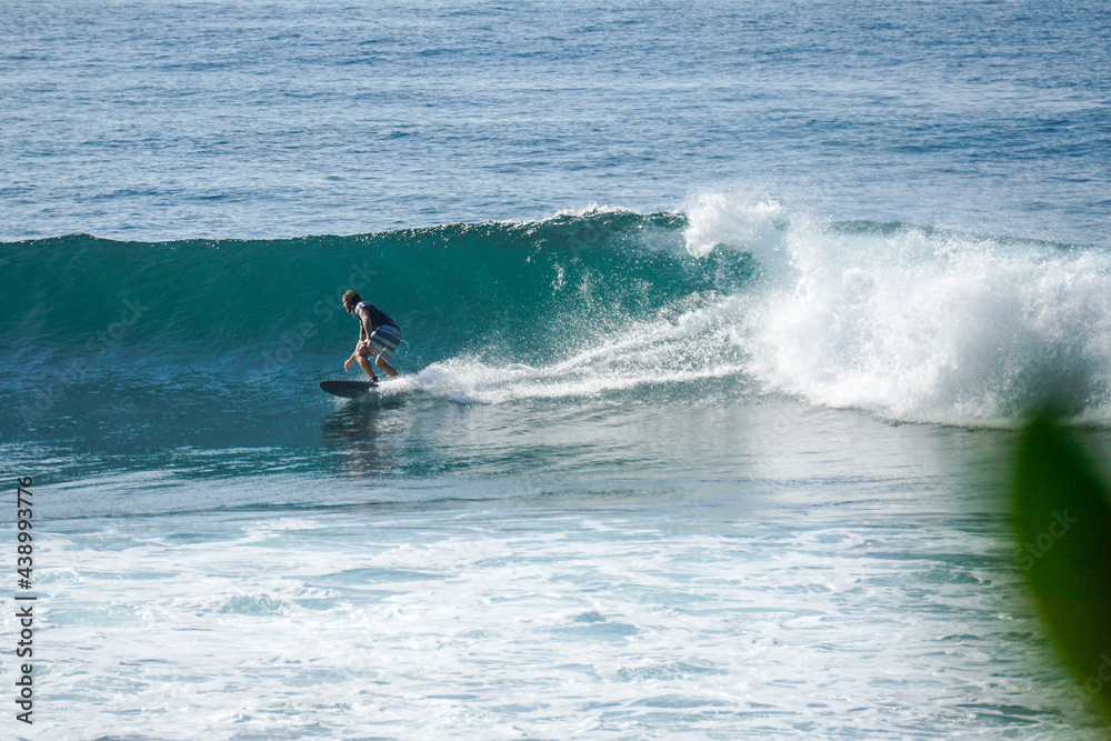 Surfer on perfect blue aquamarine wave, empty line up, perfect for surfing, clean water, Indian Ocean close to Mirissa Surfer on perfect blue aquamarine wave, empty line up, perfect for surfing, clean water, Indian Ocean close to Mirissa