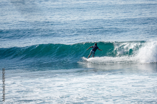 Surfer on perfect blue aquamarine wave, empty line up, perfect for surfing, clean water, Indian Ocean close to Mirissa