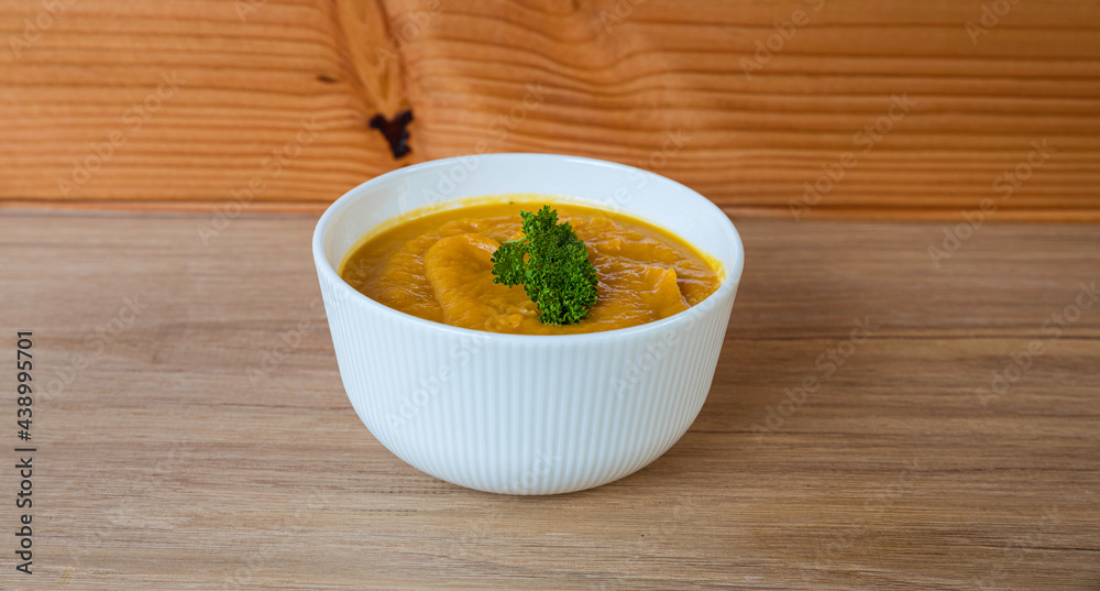a bowl of sweeet potato soup with parsley a bowl of sweeet potato soup with parsley